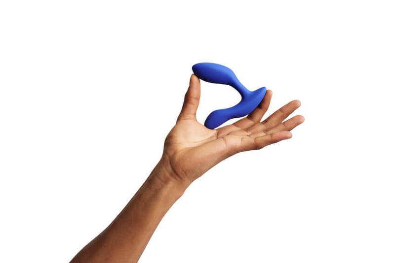 A person holds the We-Vibe Vector+. It fits comfortably between their thumb and pointer finger. The base is about the length from the base of the thumb to the tip of the pointer finger. The We-Vibe Vector+ looks slightly thicker, as an insertable, than one finger. | Kinkly Shop