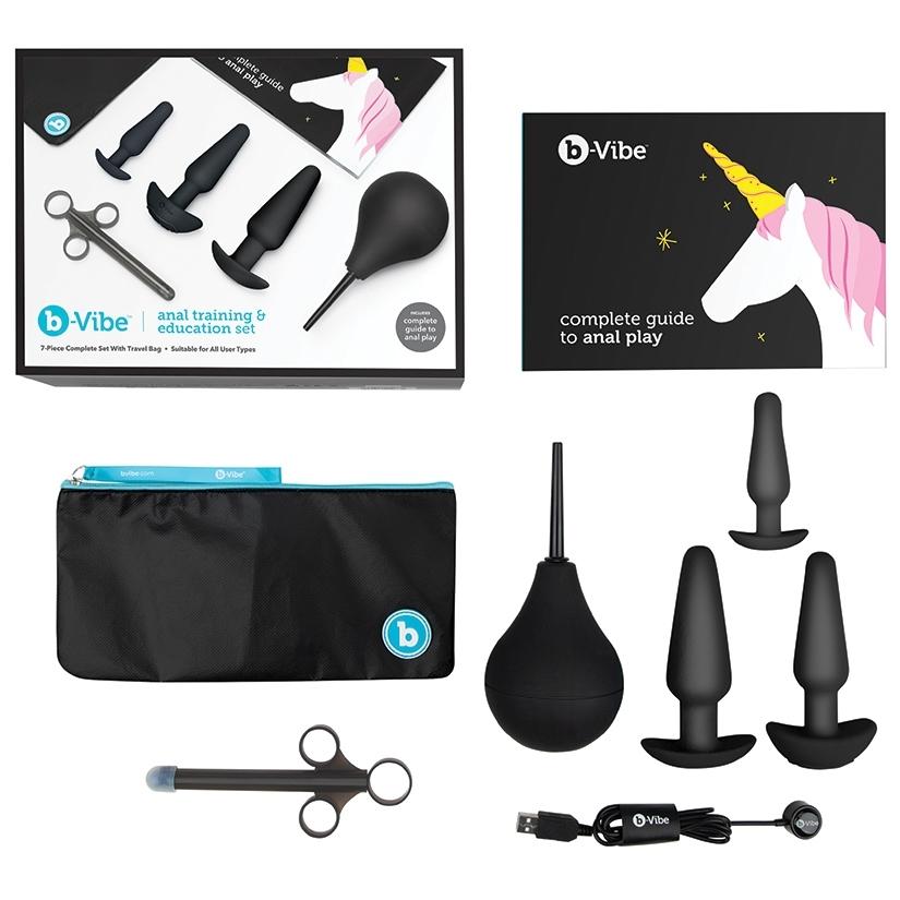 Everything that's included within the b-Vibe Anal Training Kit against a white background. The image shows the small plug, the medium plug, the large plug, the enema bulb, the lube shooter, and the full-color educational booklet. Plus the packaging! | Kinkly Shop