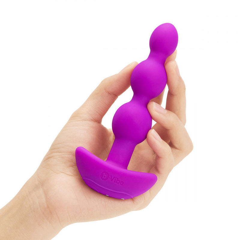 b-Vibe Triplet Anal Beads being held in a hand to show their size that's about the length of the hand | Kinkly Shop