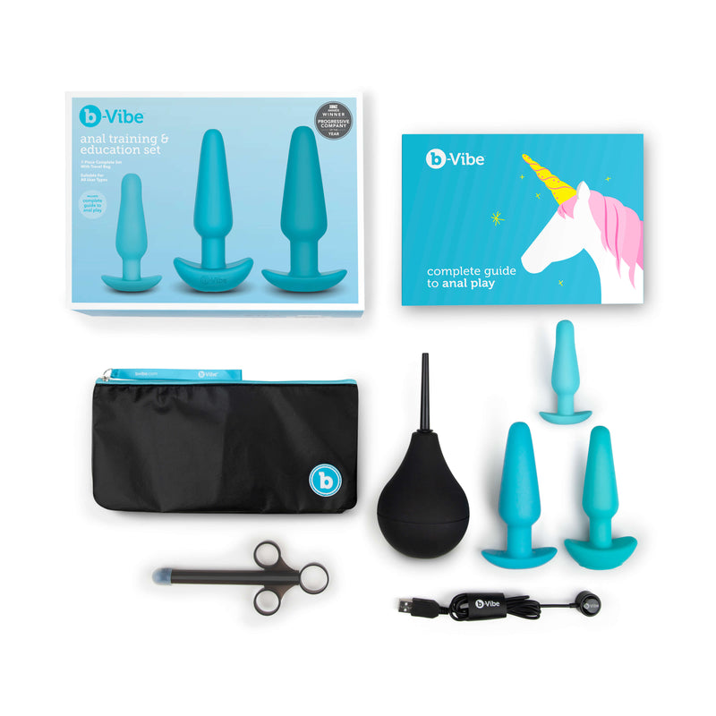 Everything that's included within the b-Vibe Anal Training Kit against a white background. The image shows the small plug, the medium plug, the large plug, the enema bulb, the lube shooter, and the full-color educational booklet. Plus the packaging! | Kinkly Shop