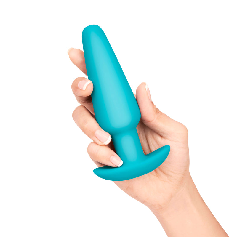 A hand holds the the Large butt plug in their hand up against a white background. | Kinkly Shop