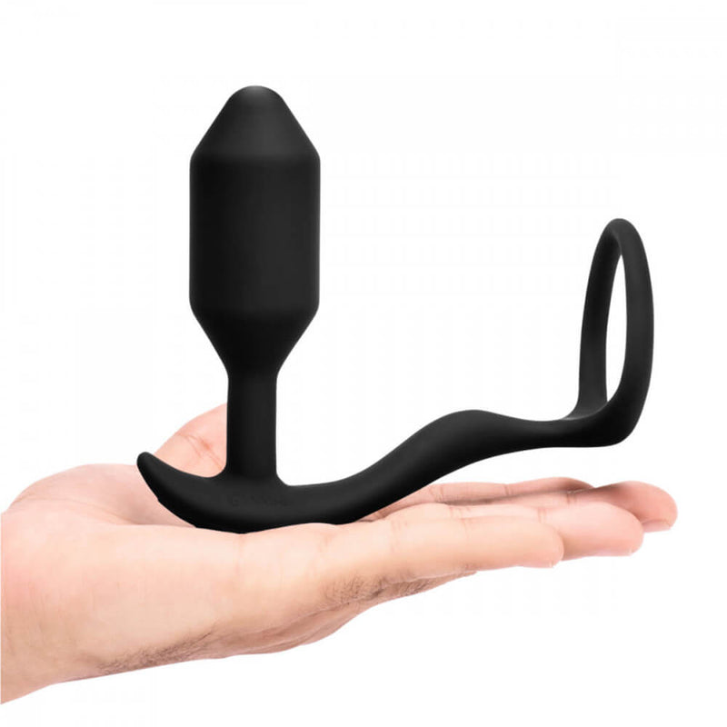 A flat hand displays the b-Vibe Vibrating Snug and Tug up against a white background. | Kinkly Shop