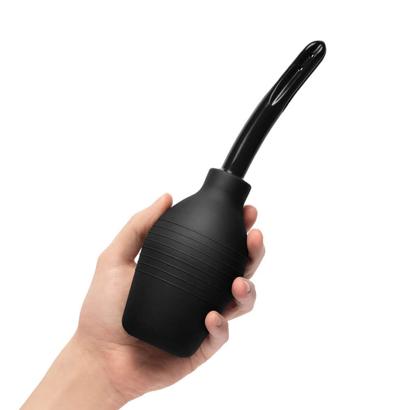 A person holds the enema bulb from the b-Vibe mASSter's Degree Anal Set. The bulb is about the size of their hand. The enema tip looks like a black, shiny plastic. | Kinkly Shop