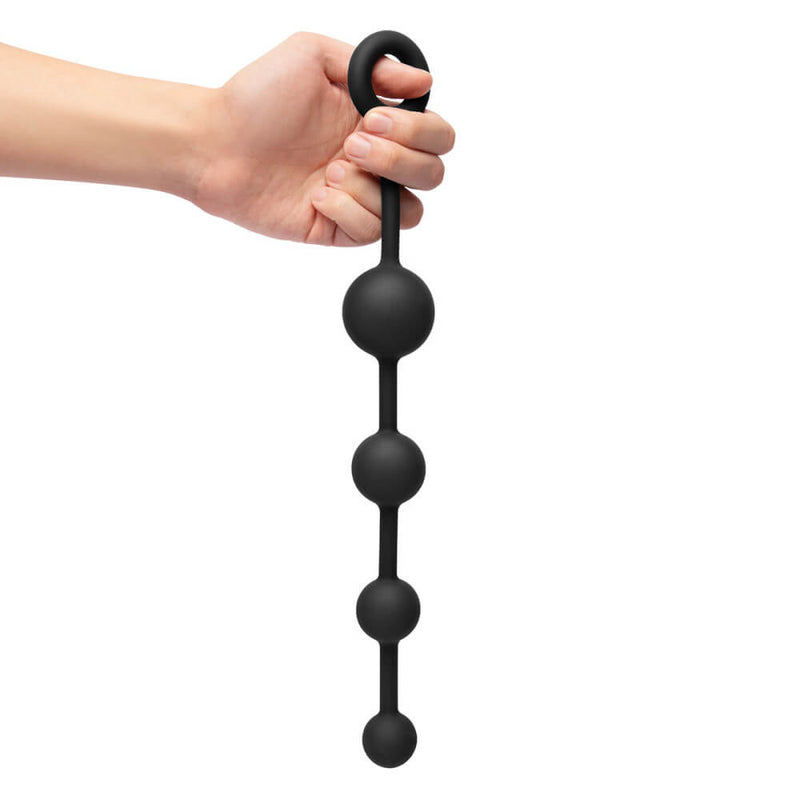 A hand holds the b-Vibe mASSter's Degree Anal Set anal beads. The beads are extremely long and look like they'd be longer than the person's forearm. | Kinkly Shop
