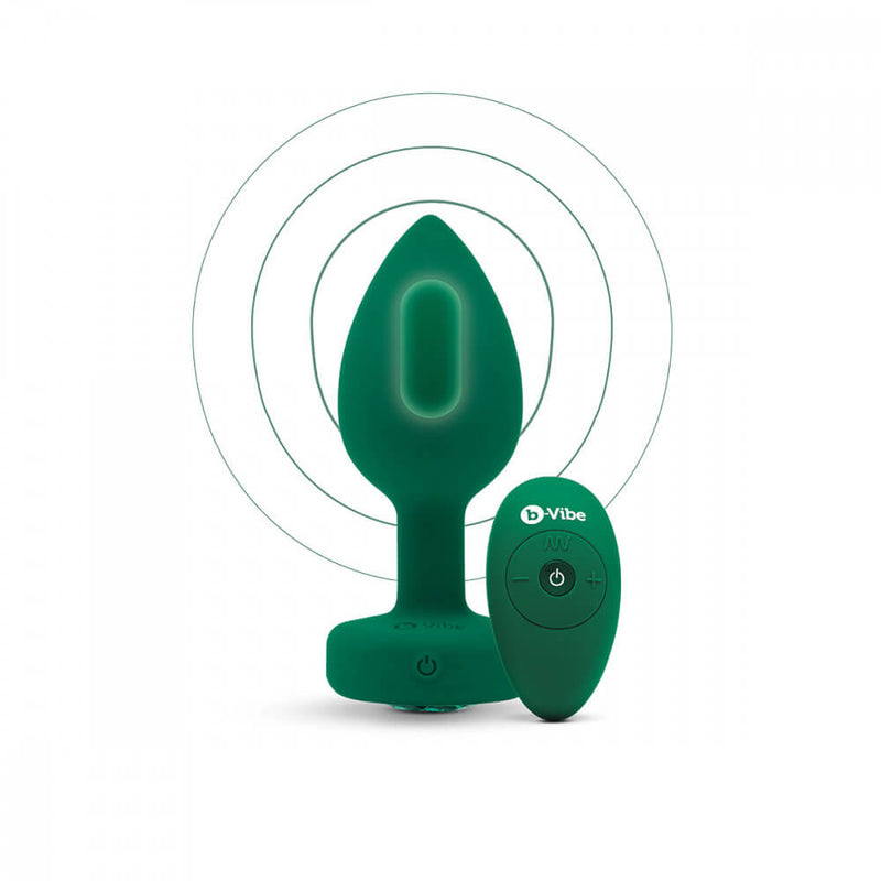 An illustrated version of an image of the b-Vibe Vibrating Jewel Remote Control Butt Plug shows where the internal motor is placed. Circles extend outward from the center of the plug (where the motor is) to signify the vibrations. | Kinkly Shop
