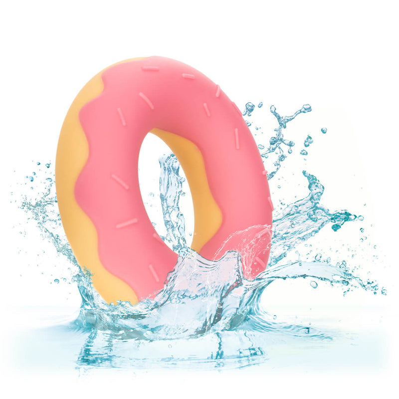 The Naughty Bits Dickin' Donuts with a water splash photoshopped around it. This is to demonstrate the cock ring's waterproof design. | Kinkly Shop