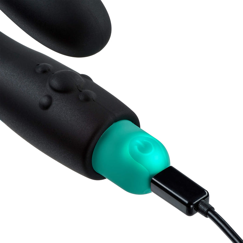 Close-up of the vibrator shows the backlight and how the vibrator looks like it is plugged into the Cloud 9 Rocker Prostate Stimulator charger. | Kinkly Shop