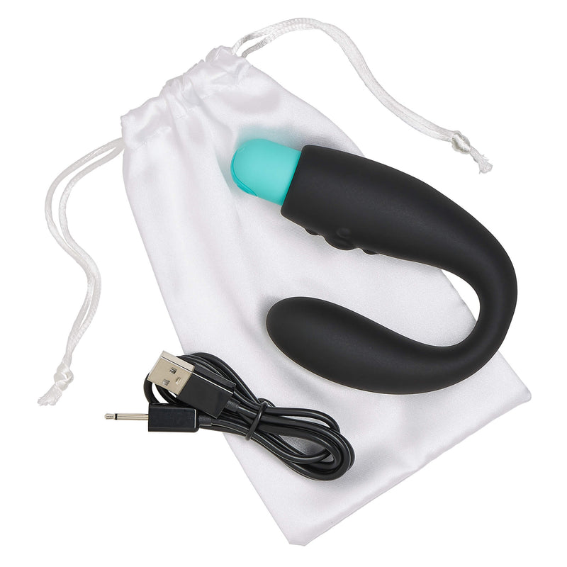 The Cloud 9 Rocker Prostate Stimulator sitting on top of its white, drawstring bag and sitting next to its charging cable. This is everything that comes with the Cloud 9 Rocker Prostate Stimulator. | Kinkly Shop