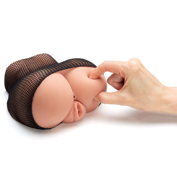 A hand pinches the squishy butt on the Cloud 9 Stroker with Removable Fishnets. This shows the size of the stroker - which is slightly larger than the hand that's pinching it. It's not a full-sized toy. | Kinkly Shop