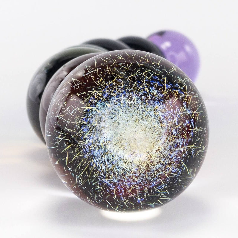 A very big close-up of the dichroic end of the Crystal Delights Rainbow Bubble glass Pride dildo. The image shows how this glass blowing technique makes it look like colorful fireworks are contained within the glass ball. | Kinkly Shop