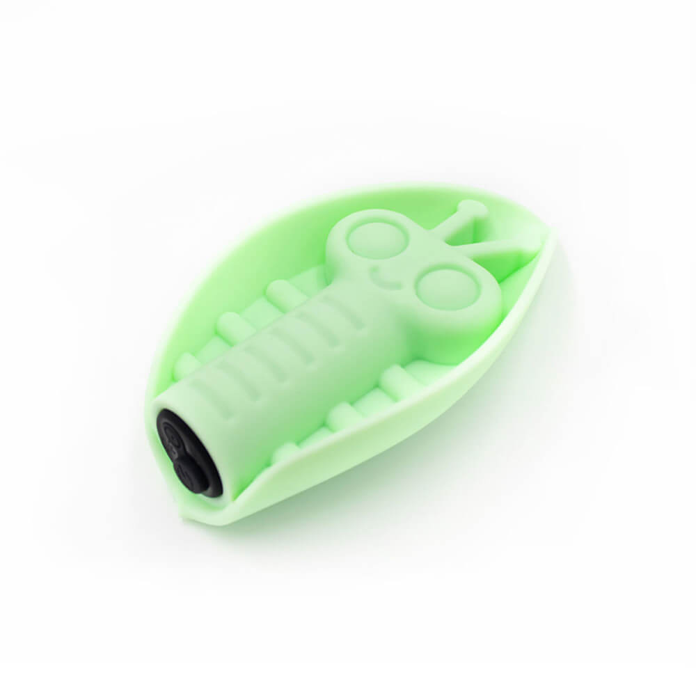 Angled view of the Cute Little Fuckers Zeep in harsh bright lighting. This lighting makes the green look much more pastel than it is, but it brings out the detail of the base. This showcases the single button on the base of the black bullet vibrator inside of the Zeep. It also showcases the charging port on the base of the vibe. | Kinkly Shop