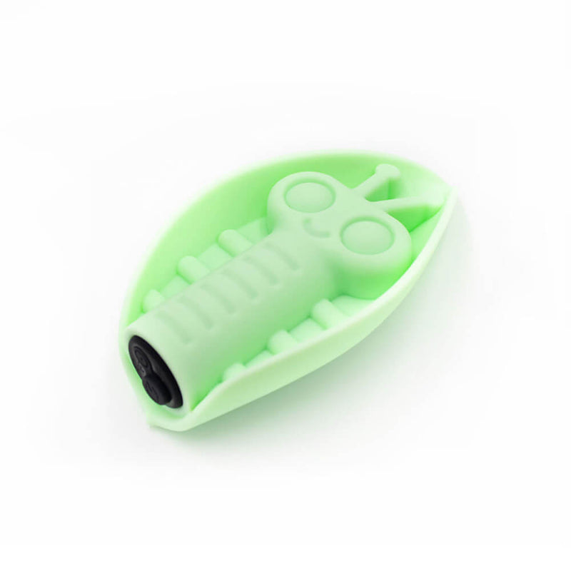 Angled view of the Cute Little Fuckers Zeep in harsh bright lighting. This lighting makes the green look much more pastel than it is, but it brings out the detail of the base. This showcases the single button on the base of the black bullet vibrator inside of the Zeep. It also showcases the charging port on the base of the vibe. | Kinkly Shop