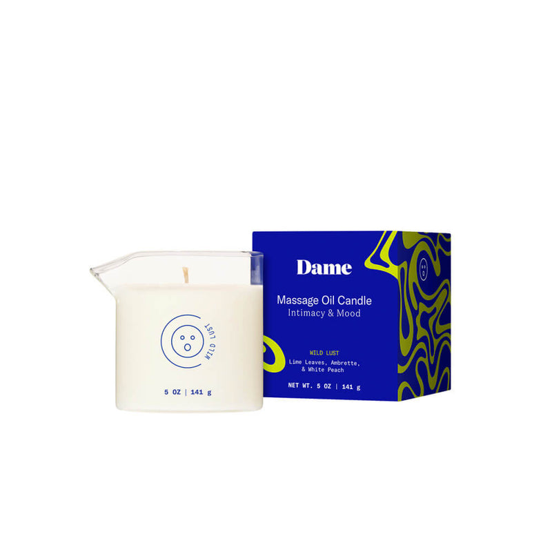 The packaging for the Dame Massage Oil Candle sitting next to the candle itself. The packaging is as small as possible, and it is barely large enough to contain the candle. It is rectangular shaped, and it would be easy to gift wrap with paper if desired. | Kinkly Shop