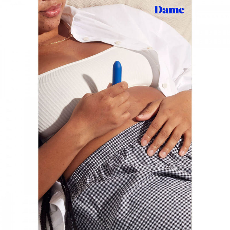A person holds the Dame Zee micro bullet vibrator. The bullet vibrator is clearly small in their hands. | Kinkly Shop