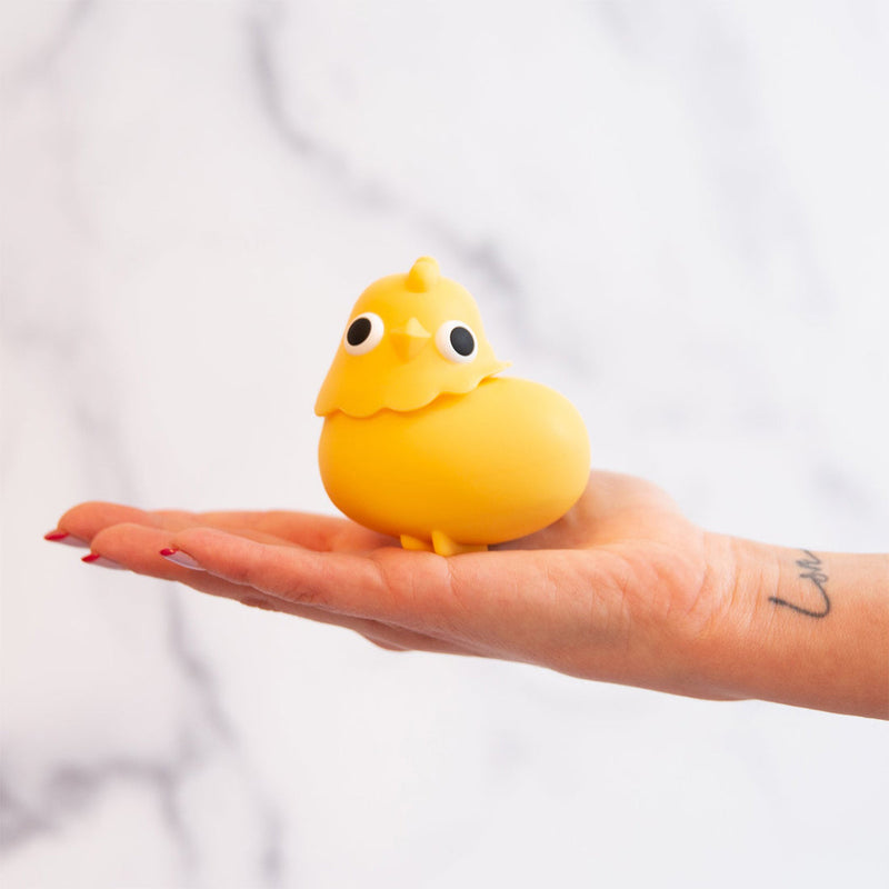 The Emojibator Chickie rests on someone's outstretched hand. It has a round, bean-like body with a head that's removable from the bean-like body to reveal the air suction hole hidden within the Chickie's head. | Kinkly Shop