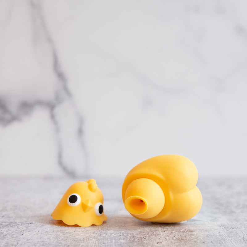 The Emojibator Chickie with its head removed. The head rests next to the body of the Chickie, displaying the air suction hole that's hidden inside of the toy. | Kinkly Shop