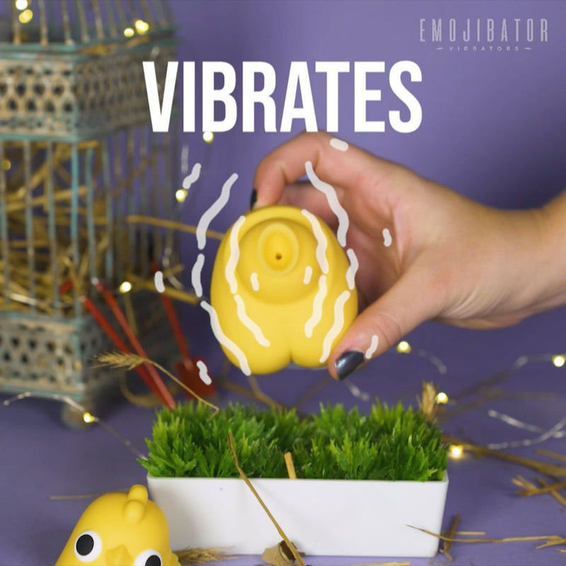 The Emojibator Chickie's head is removed and resting to the side as a hand shows us the body of the Chickie. Illustrated wave-y lines are coming out from around the vibrator with the giant word "VIBRATES" written on the image. | Kinkly Shop