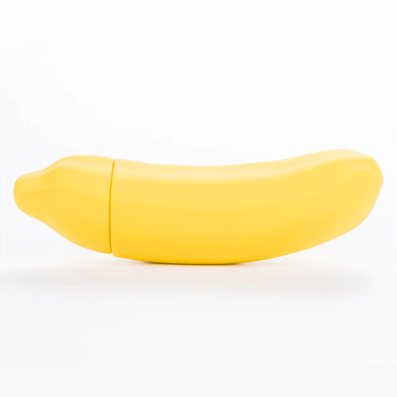 The Emojibator Banana in front of a plain white background. It has a very light curve to it with a decent girth. | Kinkly Shop
