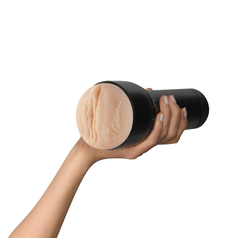 A hand holds the KIIROO FeelStars FeelLauren Stroker towards the camera. Lauren's signature is visible on the side of the orifice of the stroker. | Kinkly Shop