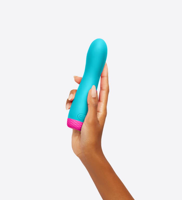 A hand holds the FemmeFunn Rora Rotating Bullet in Turquoise. The vibrator is slightly longer than the person's palm. It's about 2.5 fingers in thickness. | Kinkly Shop