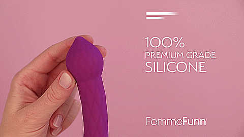 A GIF of the FemmeFunn Diamond Wand. A person holds the base of the vibrator in one hand while using their other hand to push the tip to the side. The vibrator bends in the middle to allow the tip of the toy to reach almost a 90-degree bend. Text on the GIF reads "100% Premium Grade Silicone. FemmeFunn" | Kinkly Shop