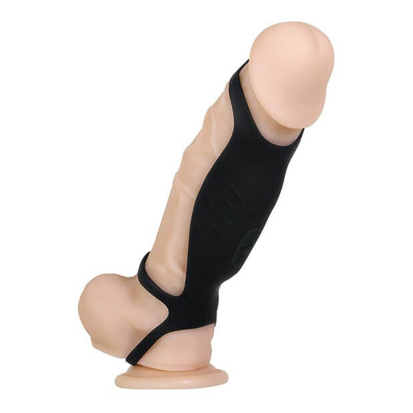 The Gender X Rocketeer wrapped around a realistic dildo. This angle showcases how the three loops wrap around the erection and how the toy is designed to fit onto an erection. | Kinkly Shop