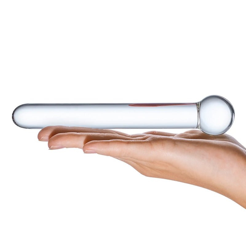 A flat palm holds the Glas 7" Straight Glass dildo. This showcases the steady diameter of the majority of the shaft that's capped off by a sphere at the base of one of the ends. | Kinkly Shop