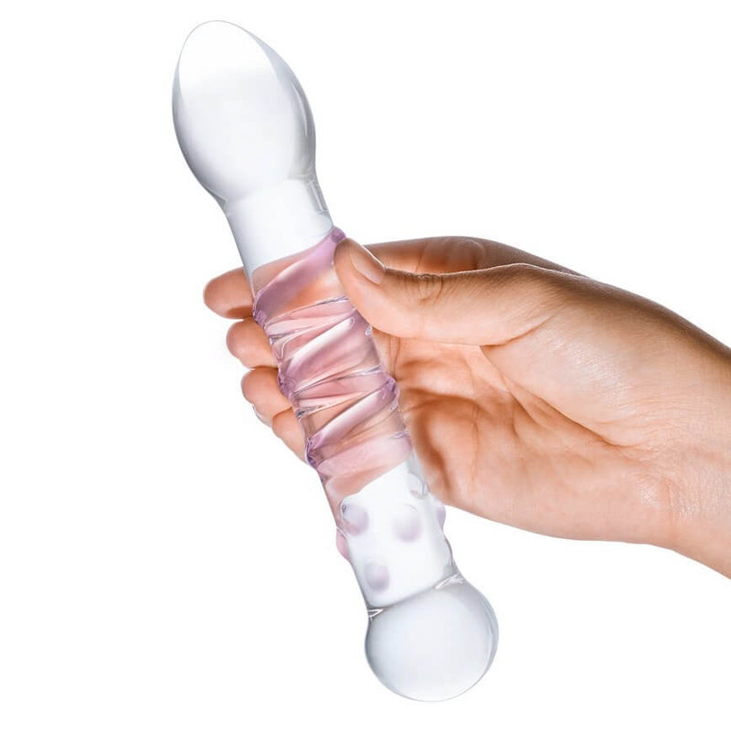 A hand grips the shaft of the Spiral Staircase glass dildo. The dildo is see-through as the hand is visible through the shaft of the dildo. | Kinkly Shop