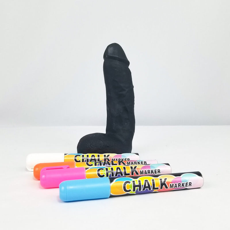A plain black Chalk Cock in front of a white background. It has not been doodled on. Four chalk markers are laid out next to it in the foreground to showcase the full kit. | Kinkly Shop