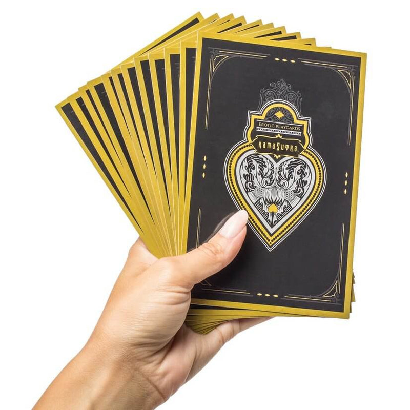 A hand holds the included erotic cards. These cards are much, much larger than standard playing cards which provides a lot of extra room for information. | Kinkly Shop