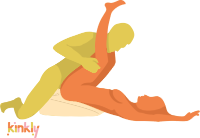 Illustration showing the Liberator Axis in use. The receiving partner is laying on their back with their legs in the air with the Liberator Axis elevating the hips. The penetrating partner leans over top of the receiving partner to penetrate. | Kinkly Shop