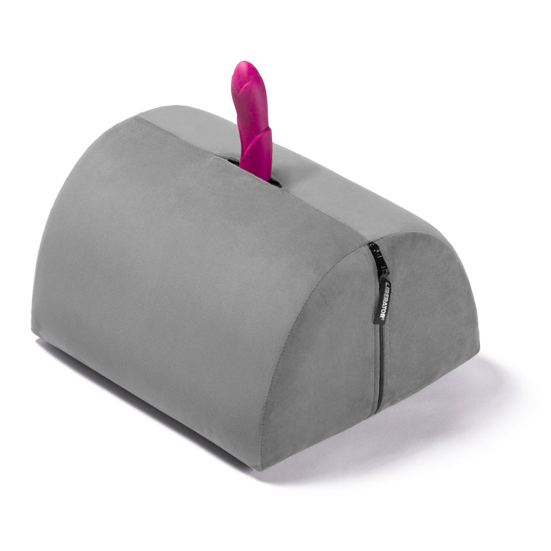 Liberator BonBon Sex Toy Mount in Grey. A sex toy is sticking out of the sex toy mount hole to showcase how the BonBon holds your favorite sex toys, hands-free. | Kinkly Shop