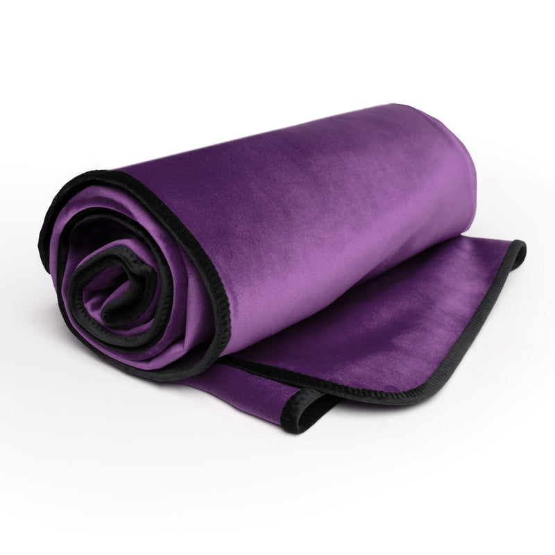 The Liberator Fascinator Throw rolled up to show the thinness and flexibility of the waterproof sex blanket. | Kinkly Shop