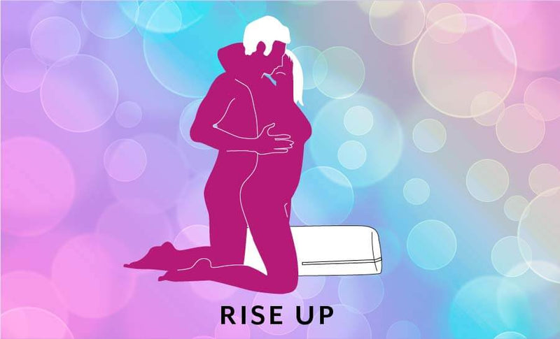 Illustrated sex position. Called "Rise Up". A couple embraces on top of the Liberator Wing. The Liberator Wing rests between the receiver's legs for support while the penetrating partner is kneeling behind them to penetrate from behind. | Kinkly Shop