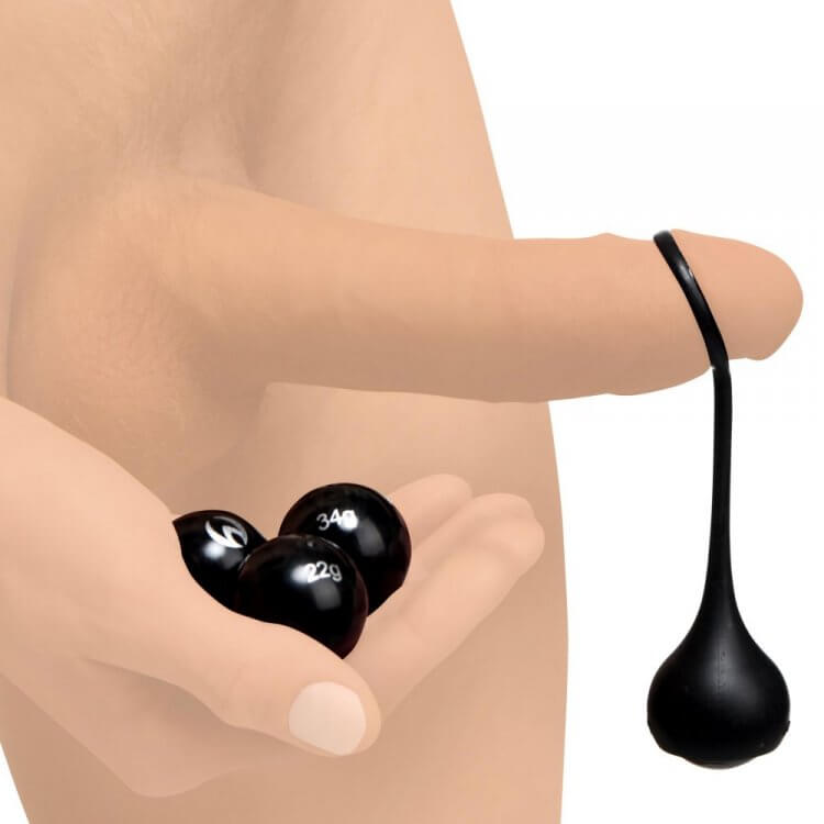 An illustration of an erect penis and a person's hand. The Master Series Cock Dangler penis weights is hanging off the tip of the erect penis while the person's hand is holding the other, unused weights. | Kinkly Shop