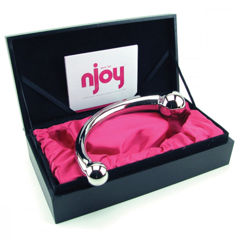 The Njoy Pure Wand in its packaging. The black box is well-above what most sex toys come with. It's a sturdy black box with ribbons tied on the edges of the lid to keep the lid upright. There's a second box inside the sturdy black exterior box. This inner box has a foam, cut-out liner that exactly fits the dildo and is covered with a bright pink satin. It's clear this packaging was designed for storage of the toy well past the initial receipt. | Kinkly Shop