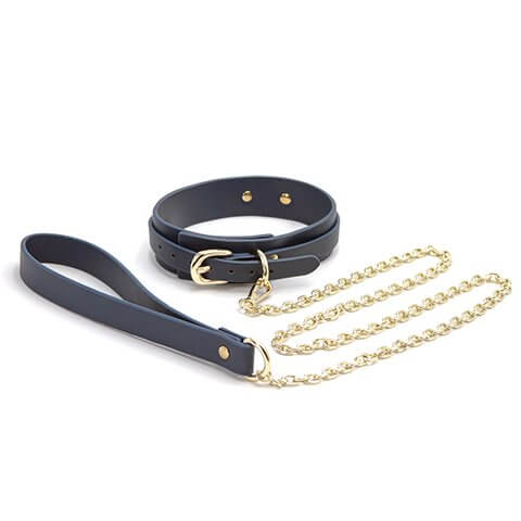 The NS Novelties Bondage Couture Vinyl Collar and Leash up against a plain white background | Kinkly Shop