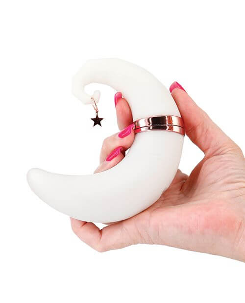 A close up of a person holding the NS Novelties Firefly Dream Glow in their hand. The vibrator is longer than their hand, and it fits into the hand with the same curvature and thickness as a large croissant. | Kinkly Shop
