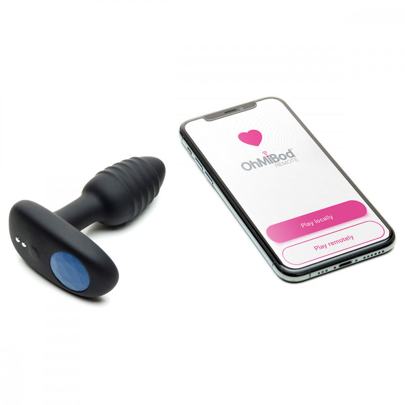 OhMiBod Lumen sitting next to a cell phone that has the OhMiBod Remote app pulled up on it | Kinkly Shop