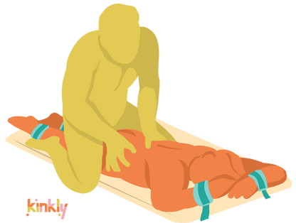 An illustrated sex position. The Bondi is laid flat, and the receiving partner is laying, length-wise, with their wrists and their ankles bound. The penetrating partner is straddling the receiving partner's hips from behind as they grip the receiving partner's lower back. | Kinkly Shop