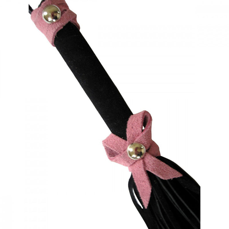 Up-close detail shot of the Ruff Doggie Styles Love Knot Travel Flogger that shows the suede bow and handle wrap detailing. It looks soft! | Kinkly Shop