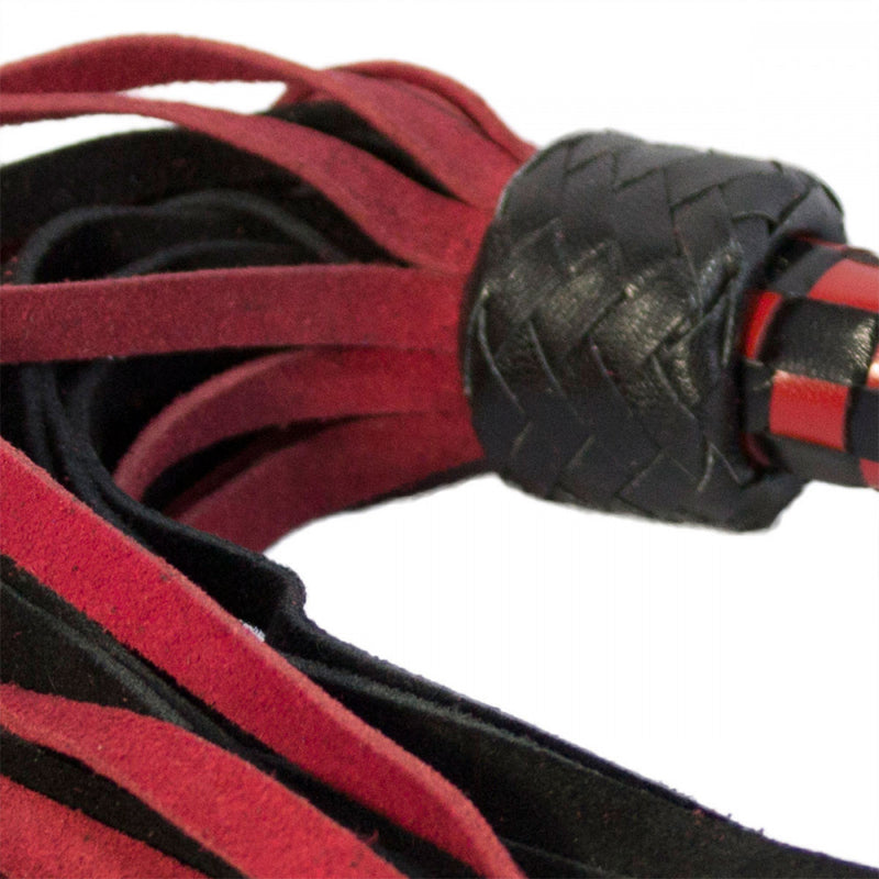 Close-up showing the texture of the suede and shiny quality of the leather handle on the Ruff Doggie Styles Short Suede Flogger | Kinkly Shop