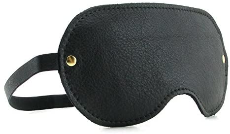 The leather blindfold included in the Spartacus Kink Kit. The image shows the immaculate stitching of the blindfold as well as the gold embellishment that fastens the blindfold to the head strap. | Kinkly Shop