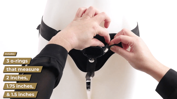GIF shows a person unsnapping the snaps that make for the interchangeable O-ring system. The person then holds up the 3 O-ring sizes that come with the Sportsheets Divine Plus Size Strap On. | Kinkly Shop