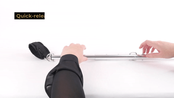 GIF shows a person using the expandable design to lengthen the Sportsheets Expandable Spreader Bar & Cuff Set | Kinkly Shop