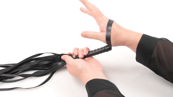 GIF shows someone handling the different pieces of the kit including the flogger and the blindfold. Text says "Soft satin blindfold". | Kinkly Shop