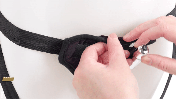 GIF shows a person inserting a bullet vibrator to the bullet vibrator pocket of the Sportsheets Lush Purple Strap On | Kinkly Shop