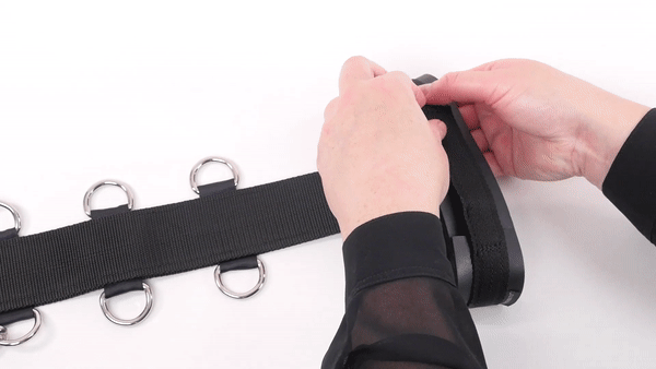 GIF shows two hands opening up the adjustable neck collar design of the Neck to Wrist Bondage Restraint and laying it flat out | Kinkly Shop
