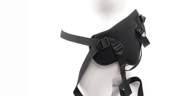 GIF shows the Sportsheets New Comer's Kit Special Edition Beginner Pegging Kit on a manequinn's hips. A person loosens and tightens the nylon straps to show how this strap on harness is adjustable. | Kinkly Shop