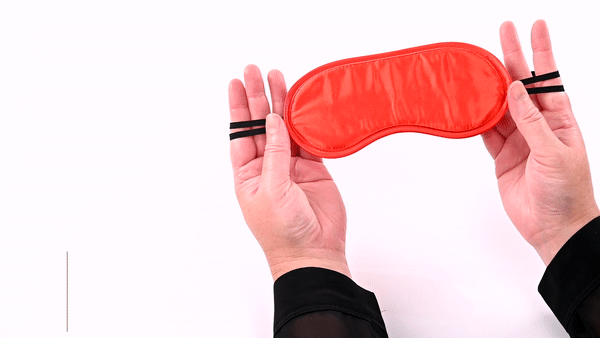GIF of the Sportsheets Satin Blindfold. GIF shows a person's hands showing off both sides of the blindfold including the two, thin, dual-elastic straps (for a comfortable fit) that keeps the blindfold on the head. | Kinkly Shop